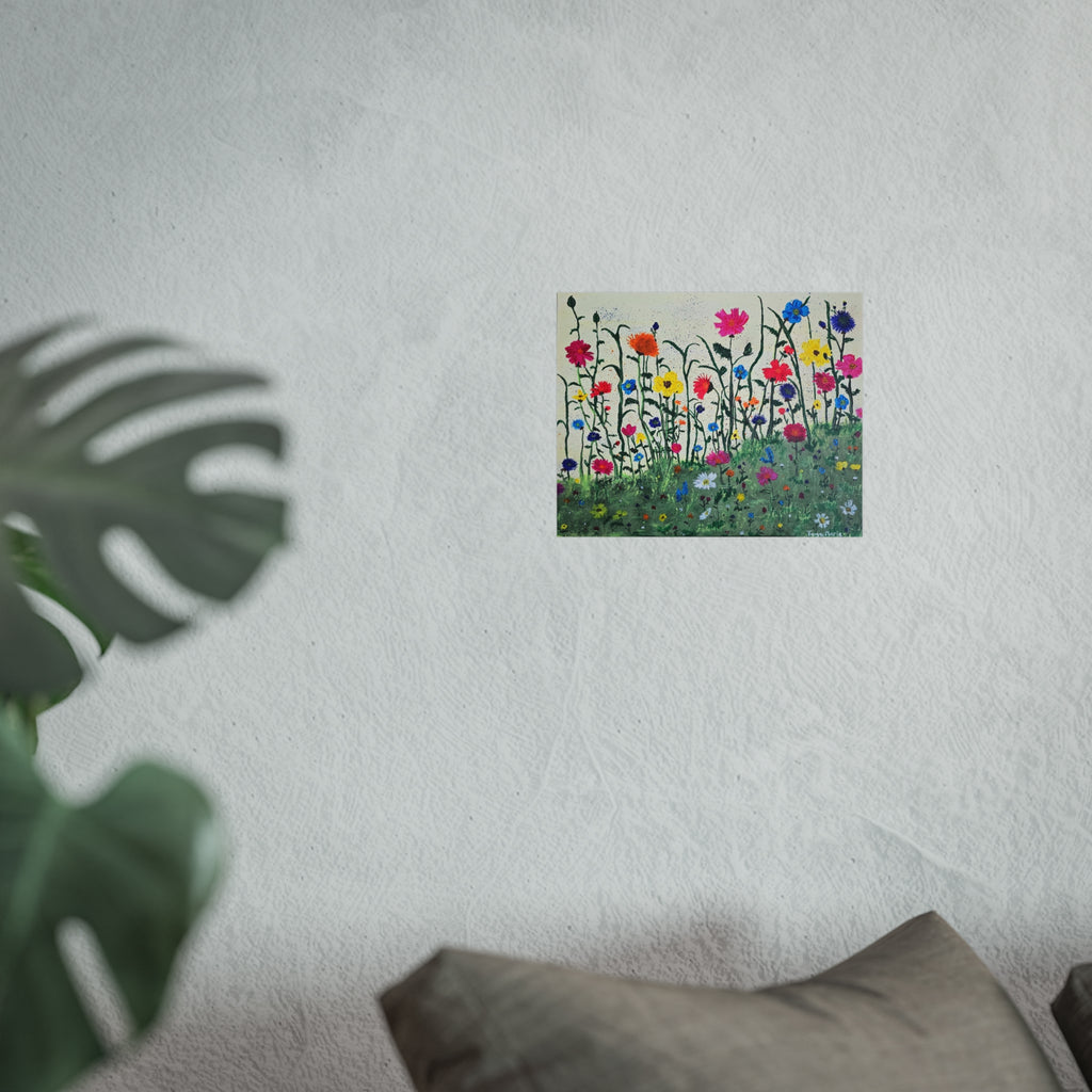 Matte floral art poster on light wall above gray sofa with greenery nearby