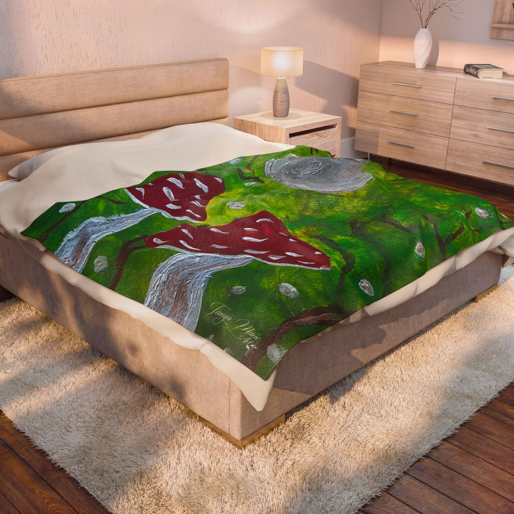 Plush velveteen blanket on bed with green woodland scene and red spotted mushrooms