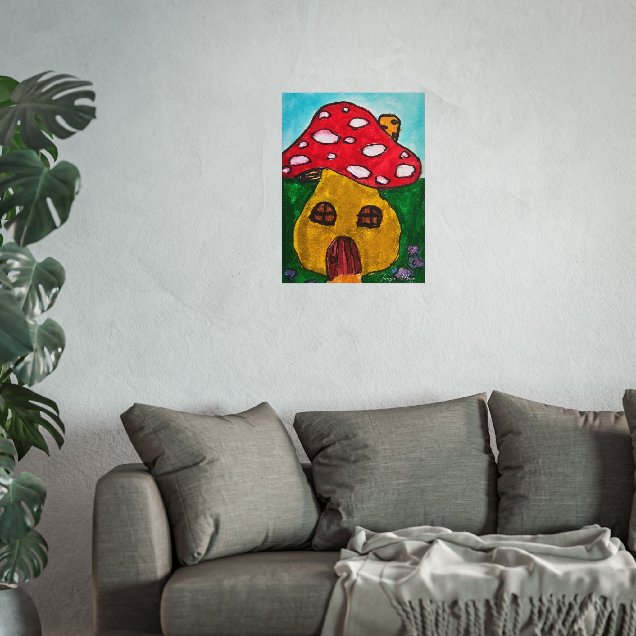 Red mushroom and yellow cottage illustration poster hung on wall