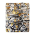 Abstract sherpa blanket with textured gold accents and bold charcoal circular scribbles