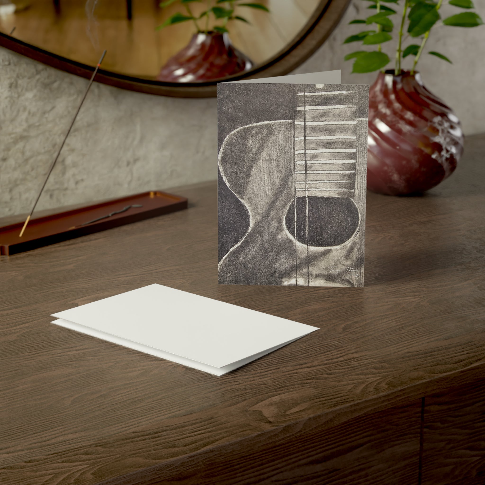 Acoustic guitar sketch greeting card featuring a grayscale guitar drawing on the front.
