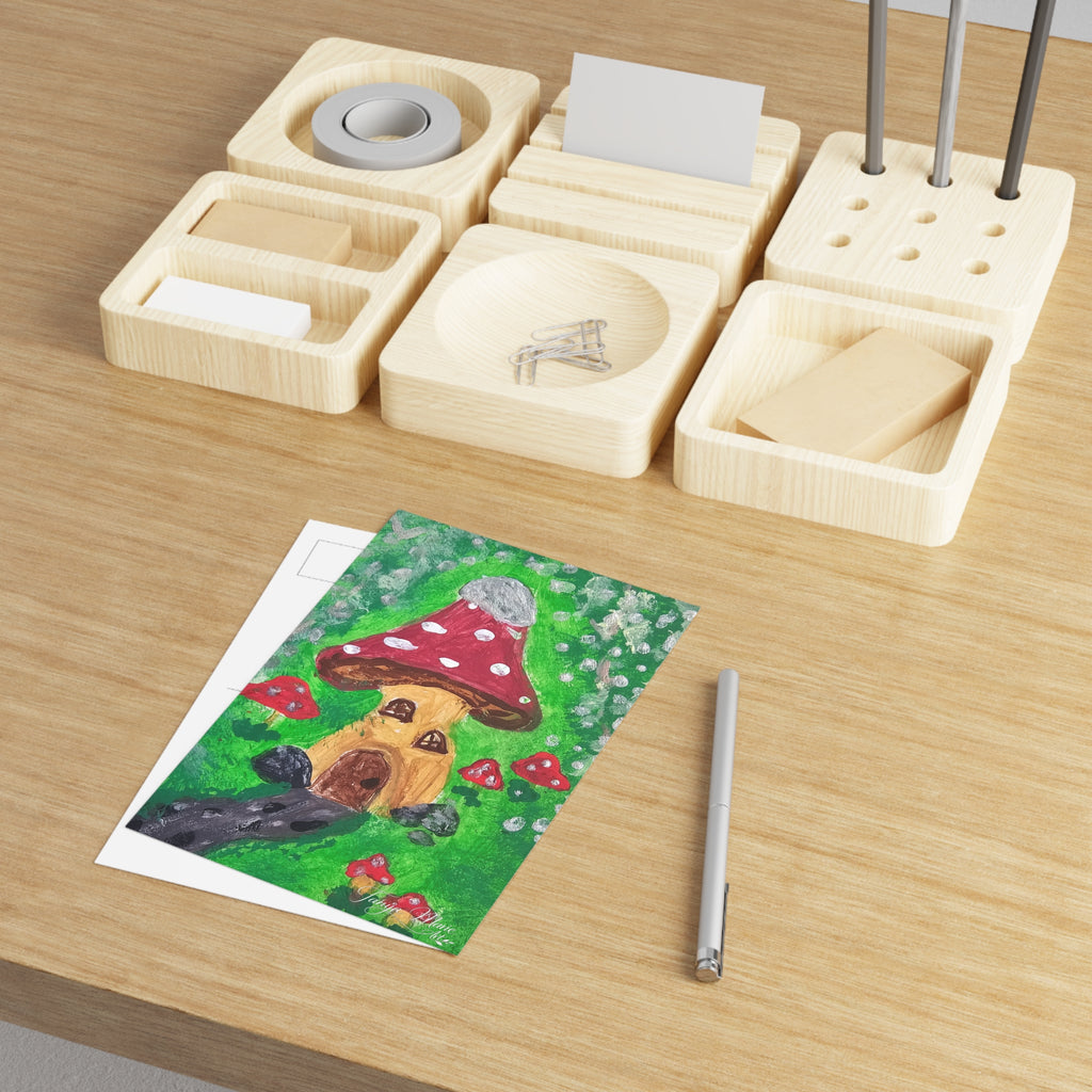 Mushroom house postcard on desk with green scene, red mushroom house, and dark forest animal
