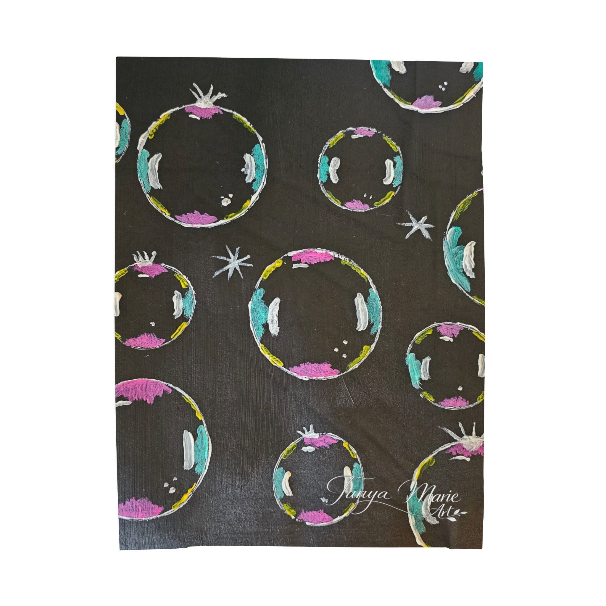 Black plush throw blanket close-up, colorful bubble ring and star prints