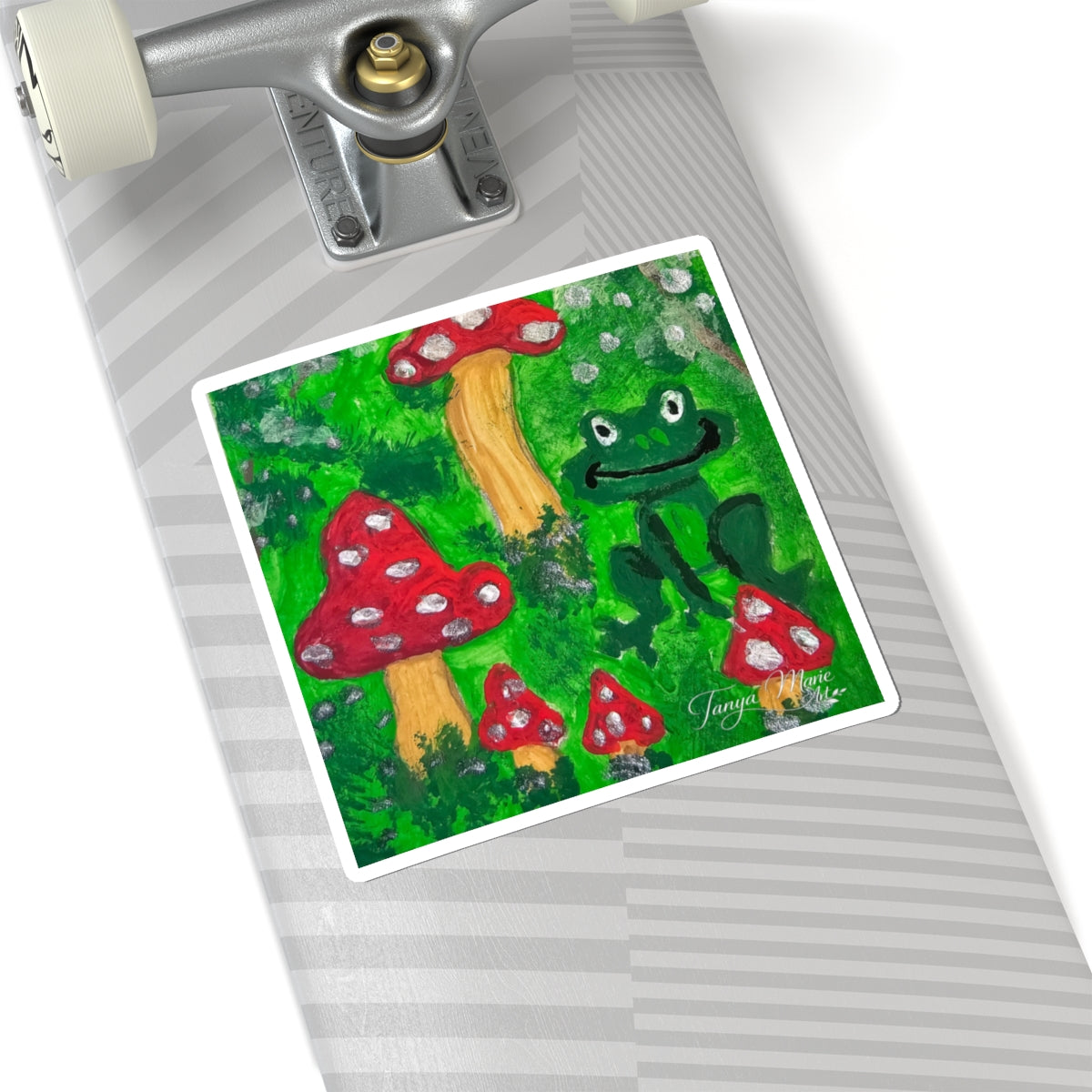 Kiss-cut sticker showing a green frog face and red toadstools, white border