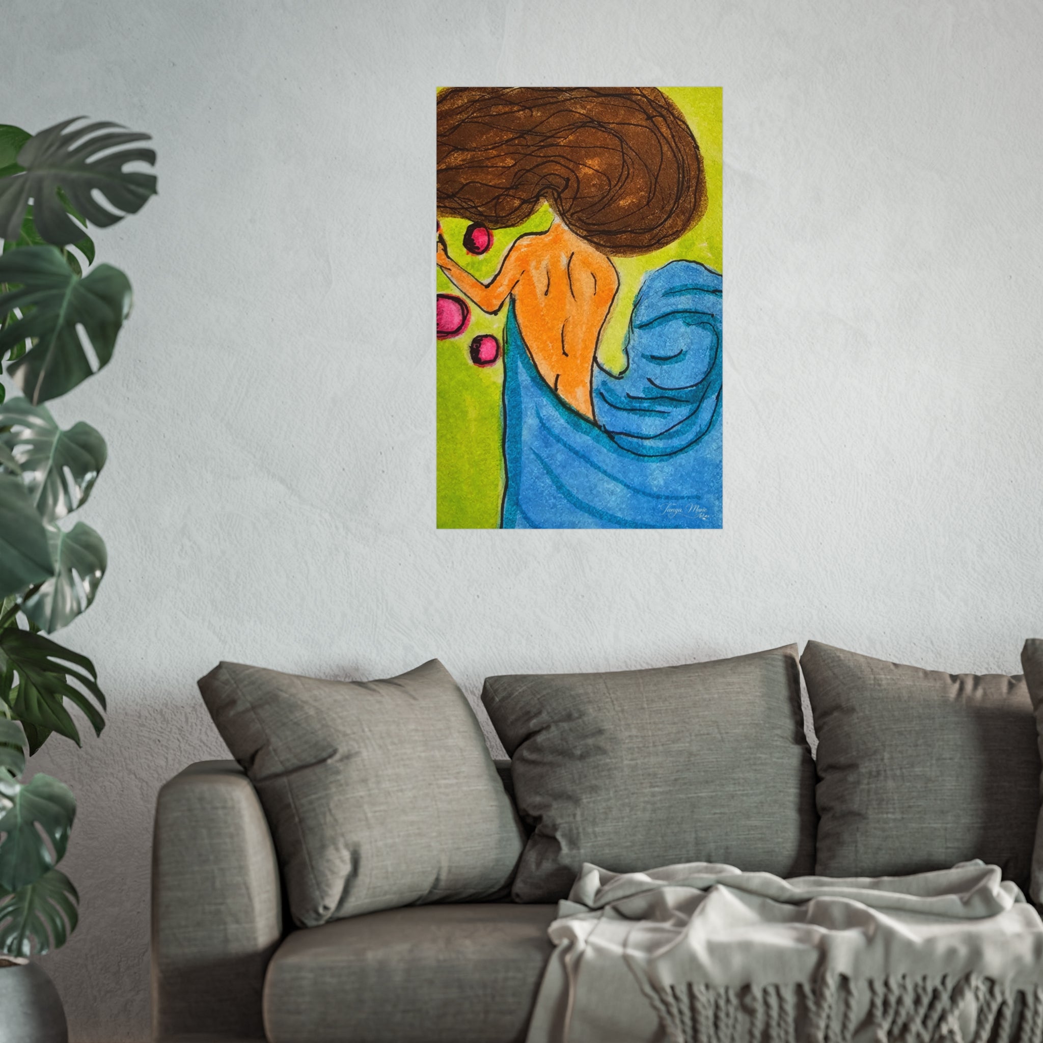 Abstract woman poster centered on wall above gray sofa, showing brown hair and blue drapery.