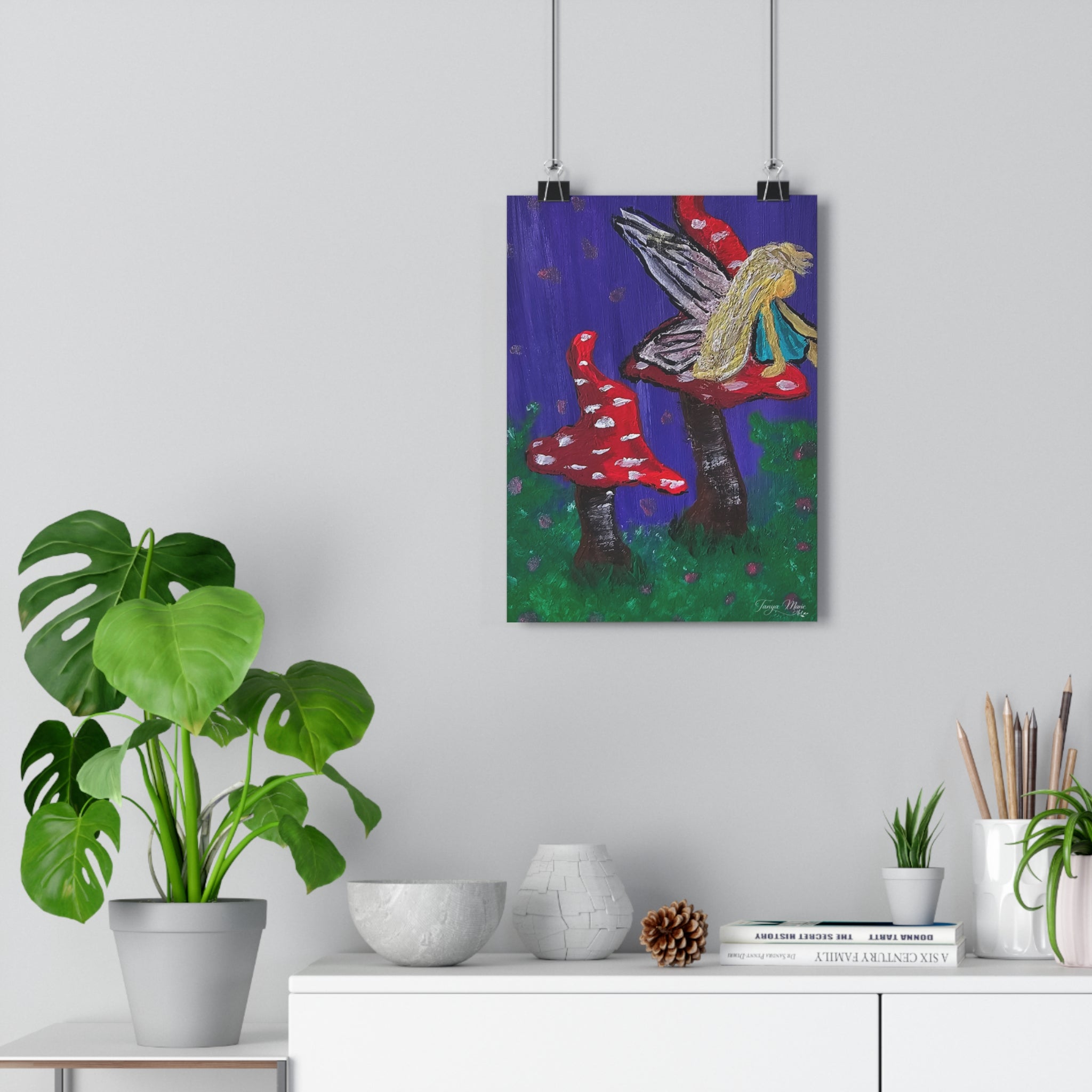 Giclée art print of a fairy sitting on red toadstools with purple and green accents