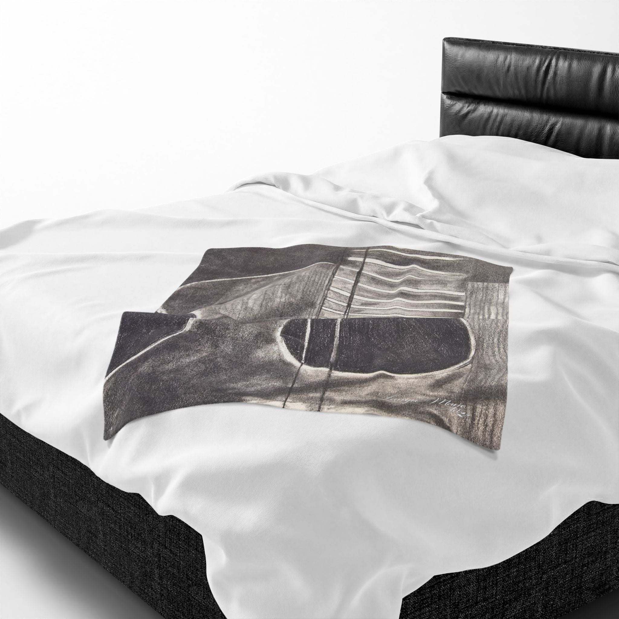Plush blanket detail: acoustic guitar sketch graphic in dark gray on white