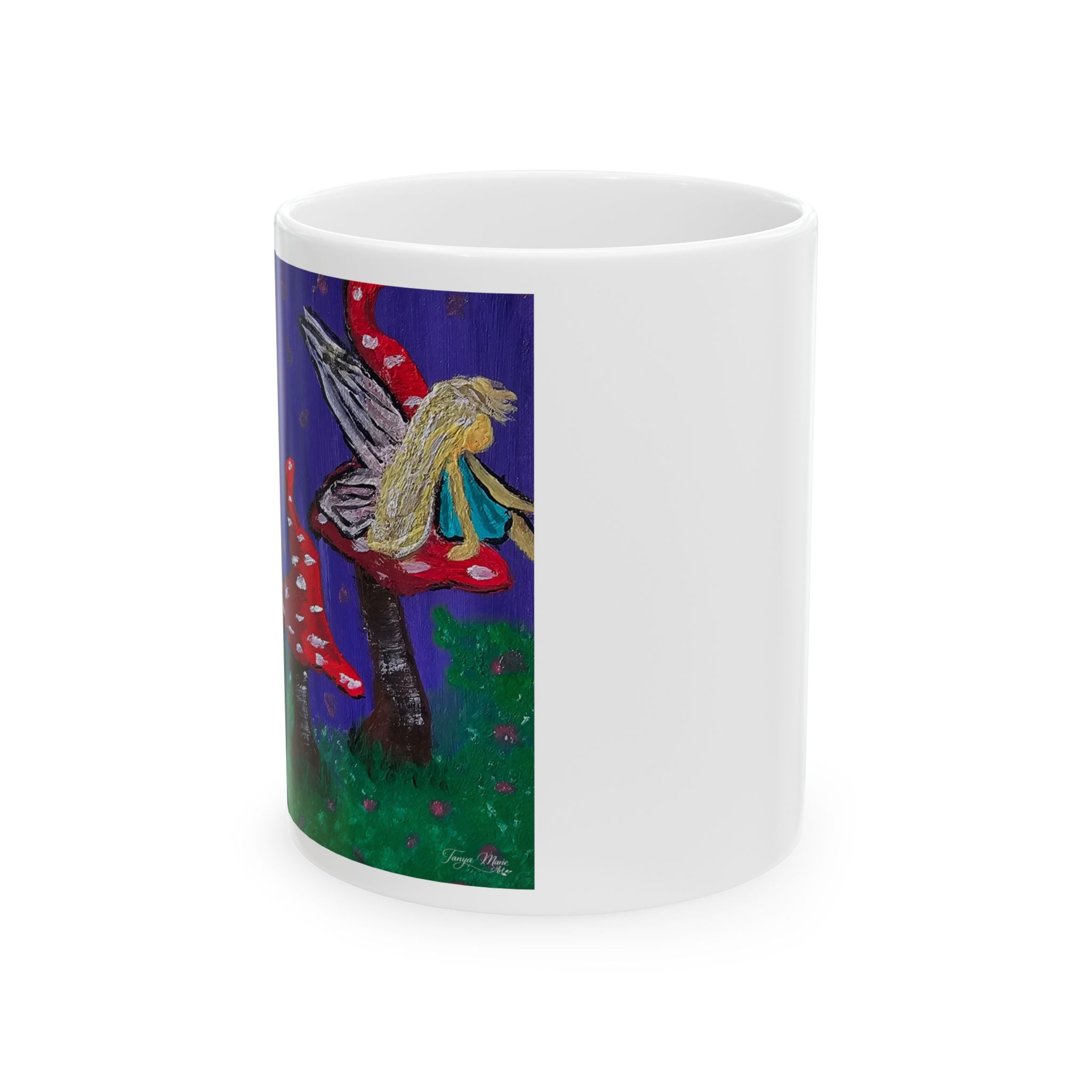 White ceramic mug with wraparound fairy and red toadstool artwork