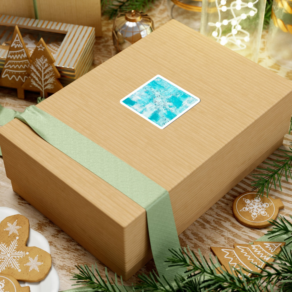 Teal abstract art sticker with white border on wrapped gift box