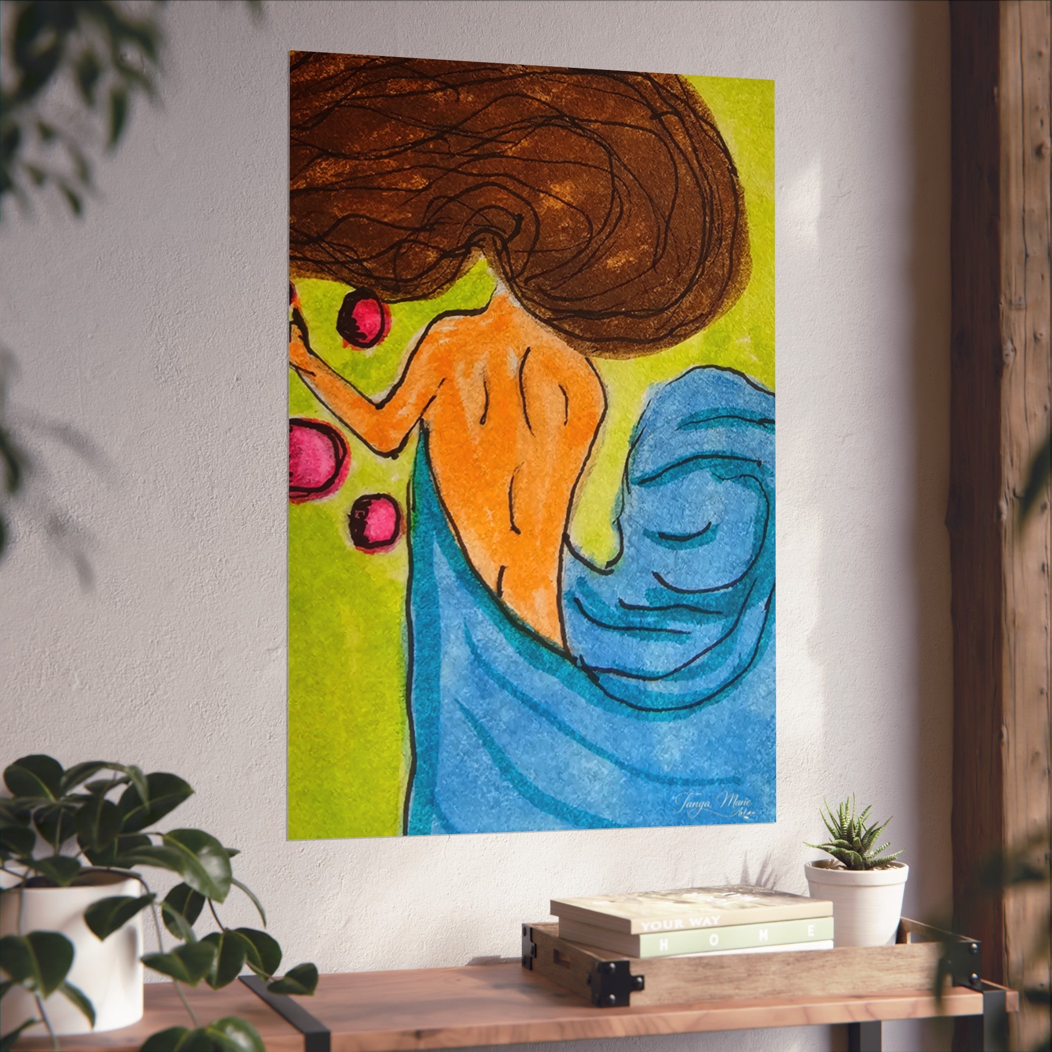 Matte abstract woman poster on wall with orange face, brown hair, and blue drapery.