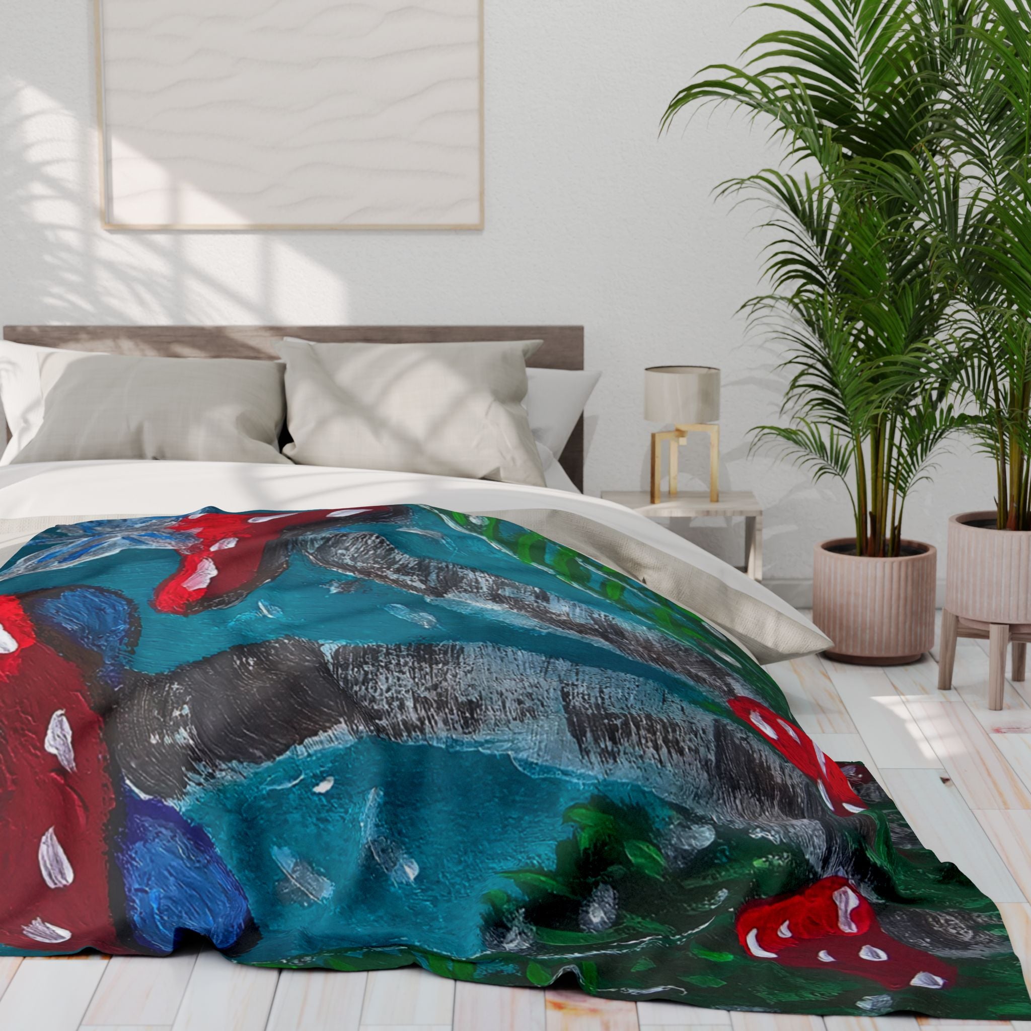 Fleece blanket on a bed, featuring teal-blue stripes, dark trunks, and red mushrooms
