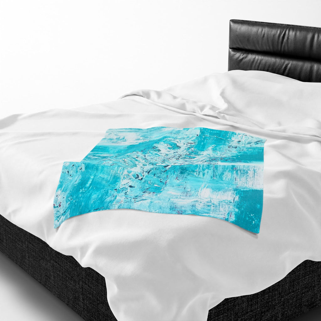 Turquoise abstract plush throw blanket with blue rectangle artwork on white fabric