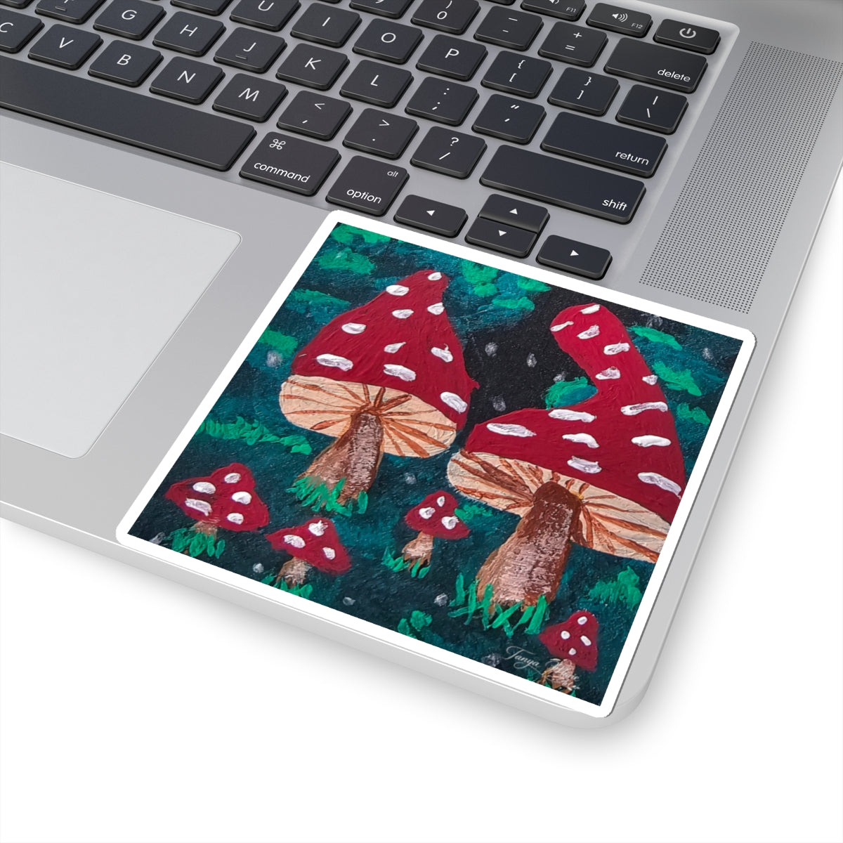 Kiss-cut sticker on laptop: red spotted mushroom illustration with white border