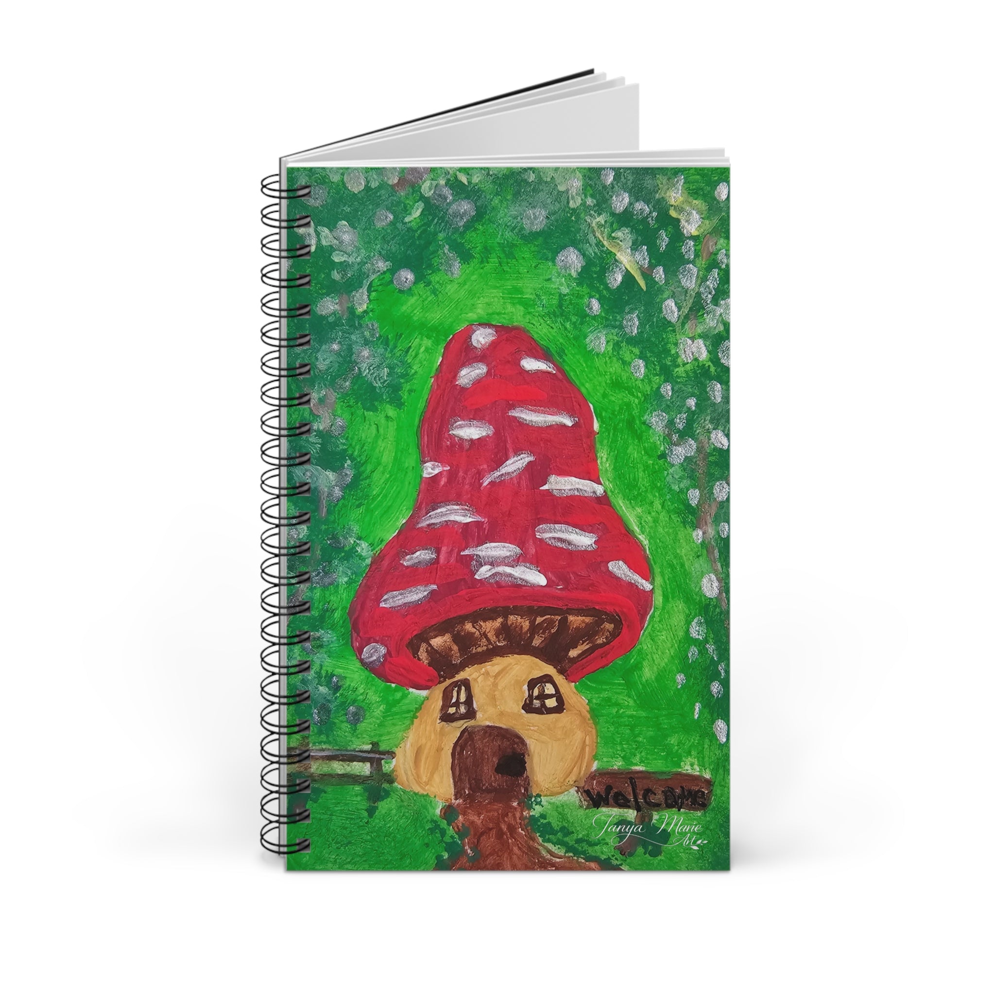 Spiral notebook with red mushroom house cover illustration, pages slightly fanned open