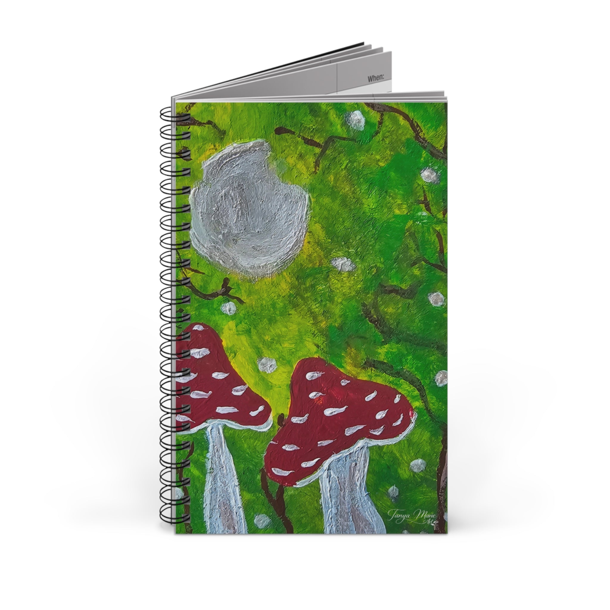 Stacked spiral nature journals with green illustrated covers and red mushroom artwork