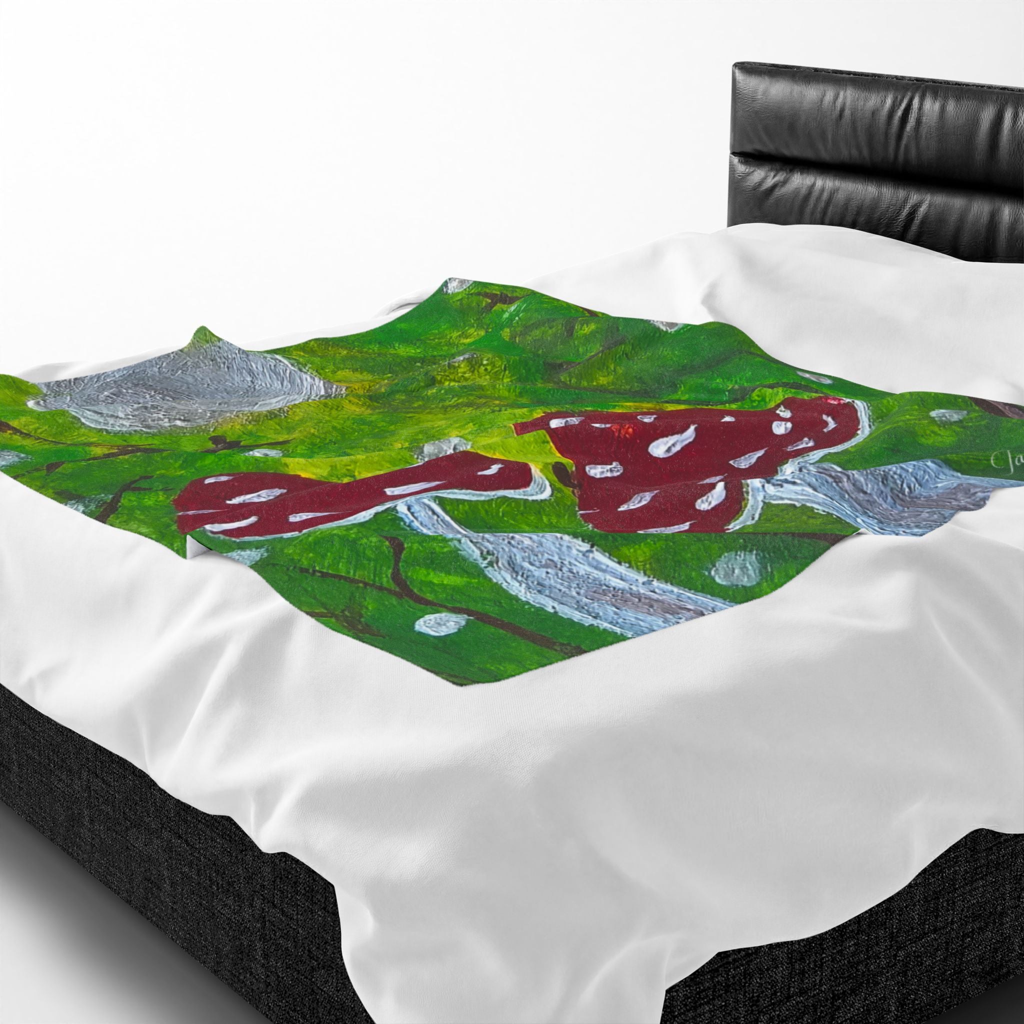 Plush velveteen blanket close-up: green forest with red mushrooms and gray stones