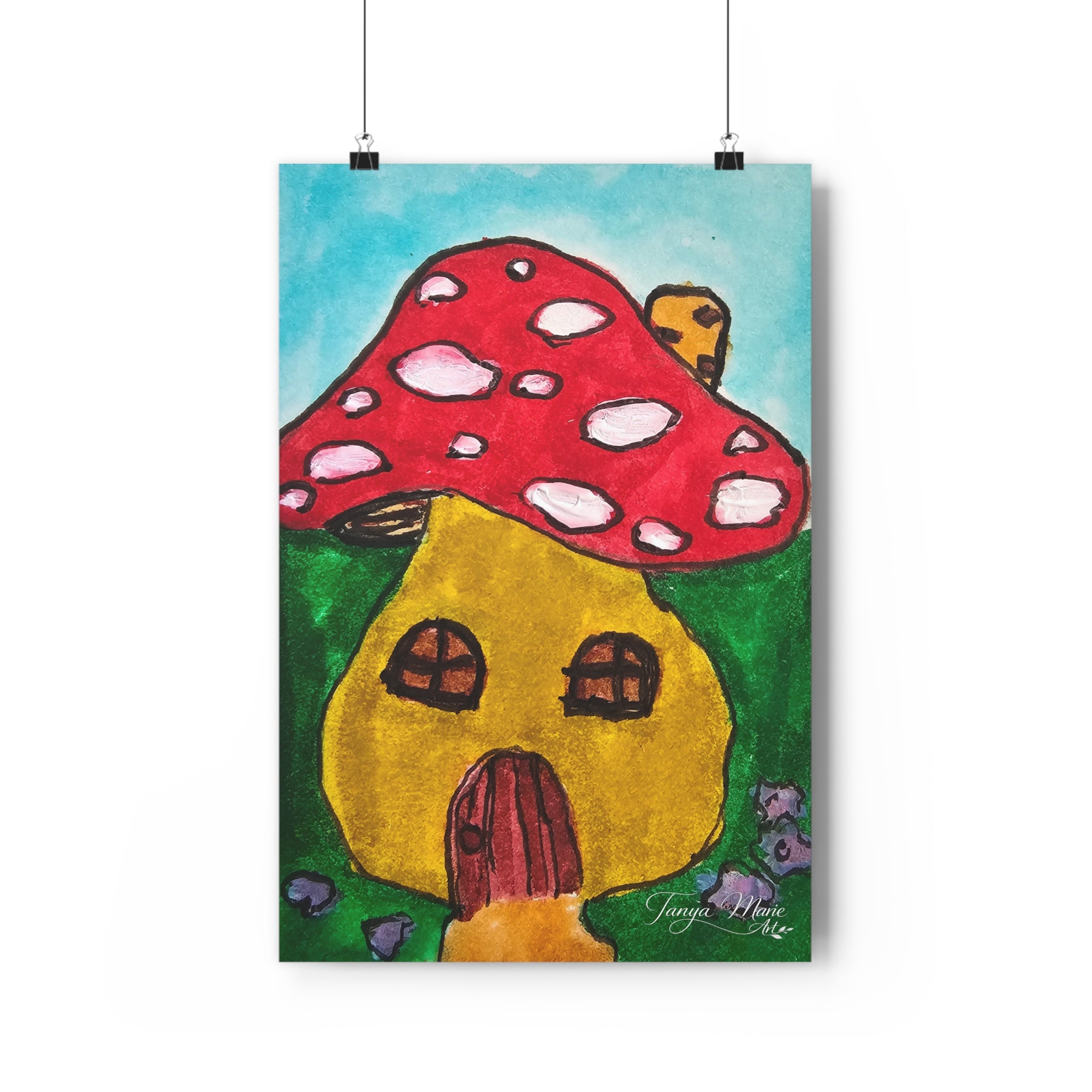 Mushroom cottage wall art print with red mushroom cap and yellow house, hanging by cords