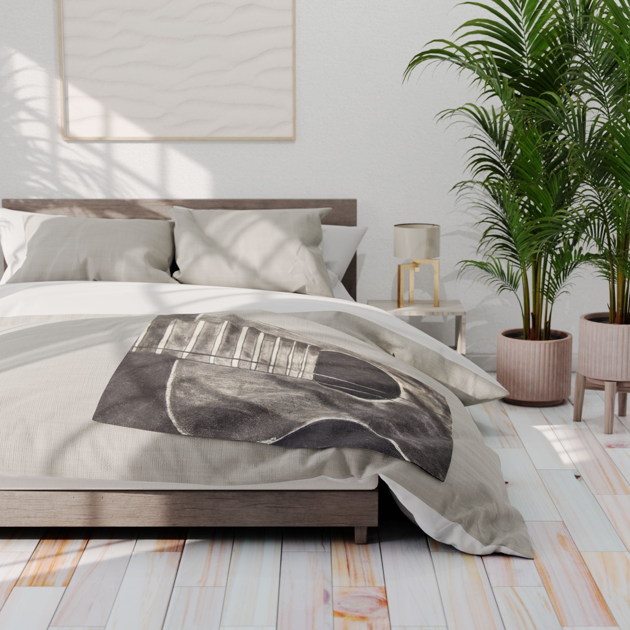 Gray acoustic guitar sketch fleece blanket on bed, featuring guitar body and strings design