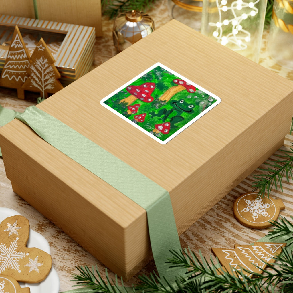Kiss-cut garden sticker with green frog and red toadstools, white outline on kraft box