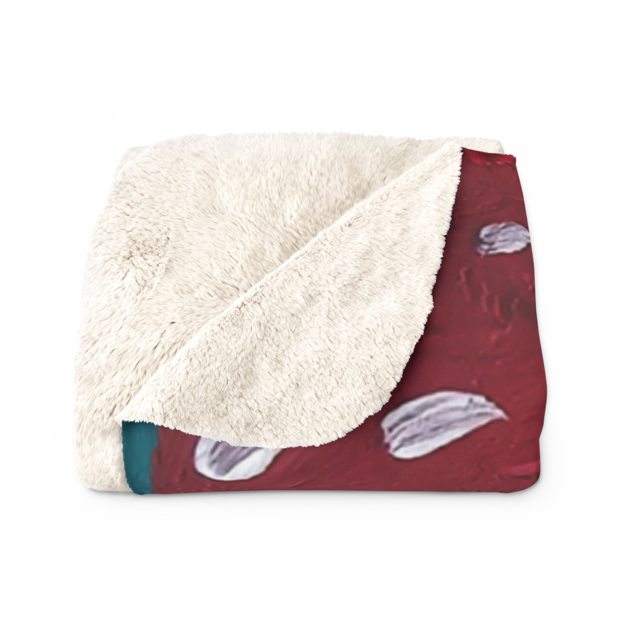 Sherpa fleece blanket with white fluffy underside and red mushroom print edge.