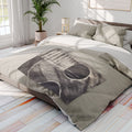 Gray acoustic guitar sketch fleece blanket draped on bed, showing guitar body and strings