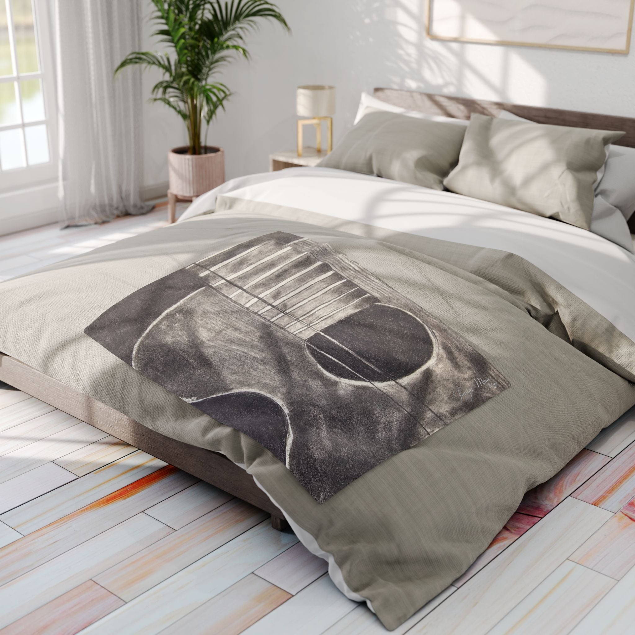 Gray acoustic guitar sketch fleece blanket draped on bed, showing guitar body and strings