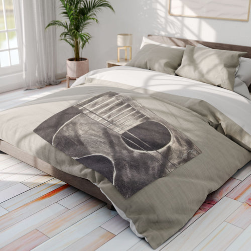 Gray acoustic guitar sketch fleece blanket draped on bed, showing guitar body and strings