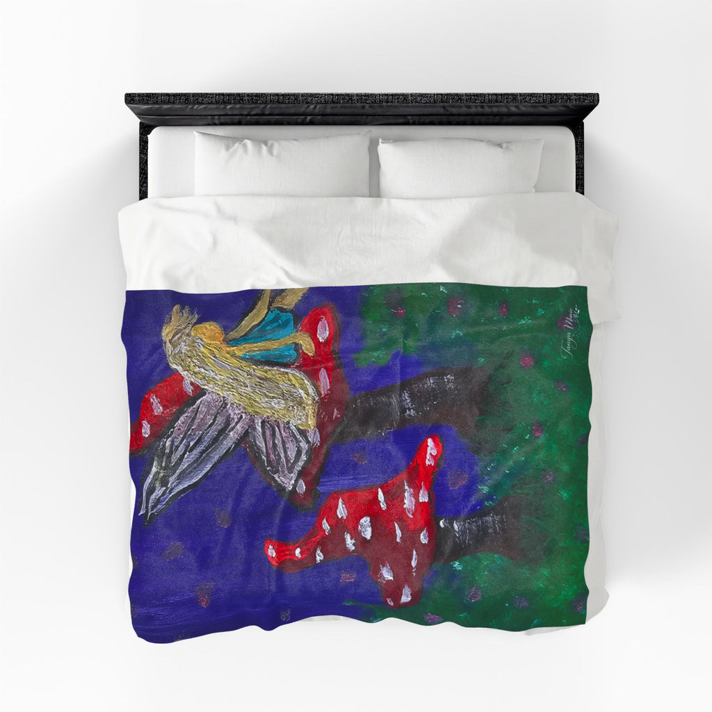 Plush velveteen blanket with fairy wings, red toadstools, and green ground accents