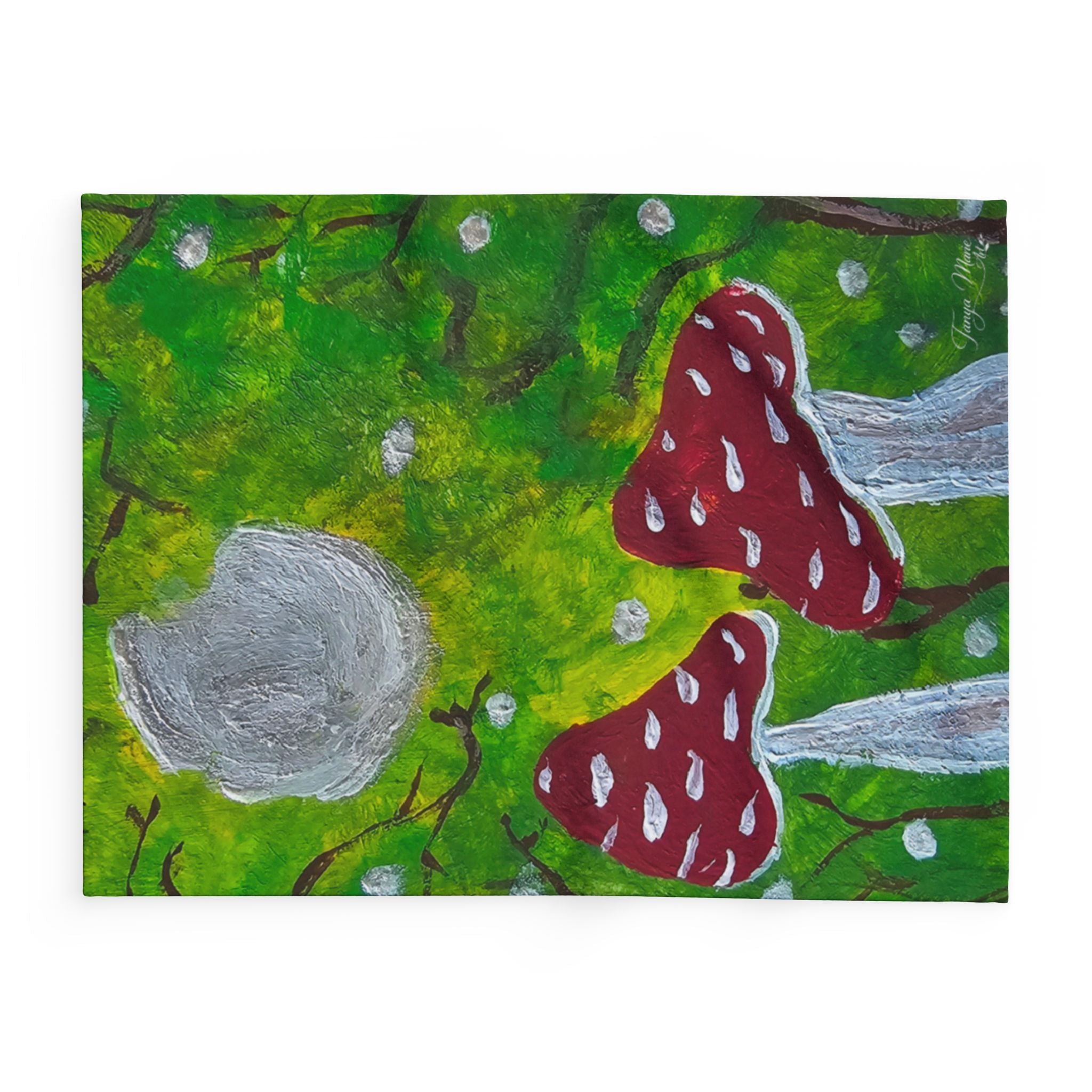 Fleece blanket with red mushrooms, gray moon rock, and green leaves branch details