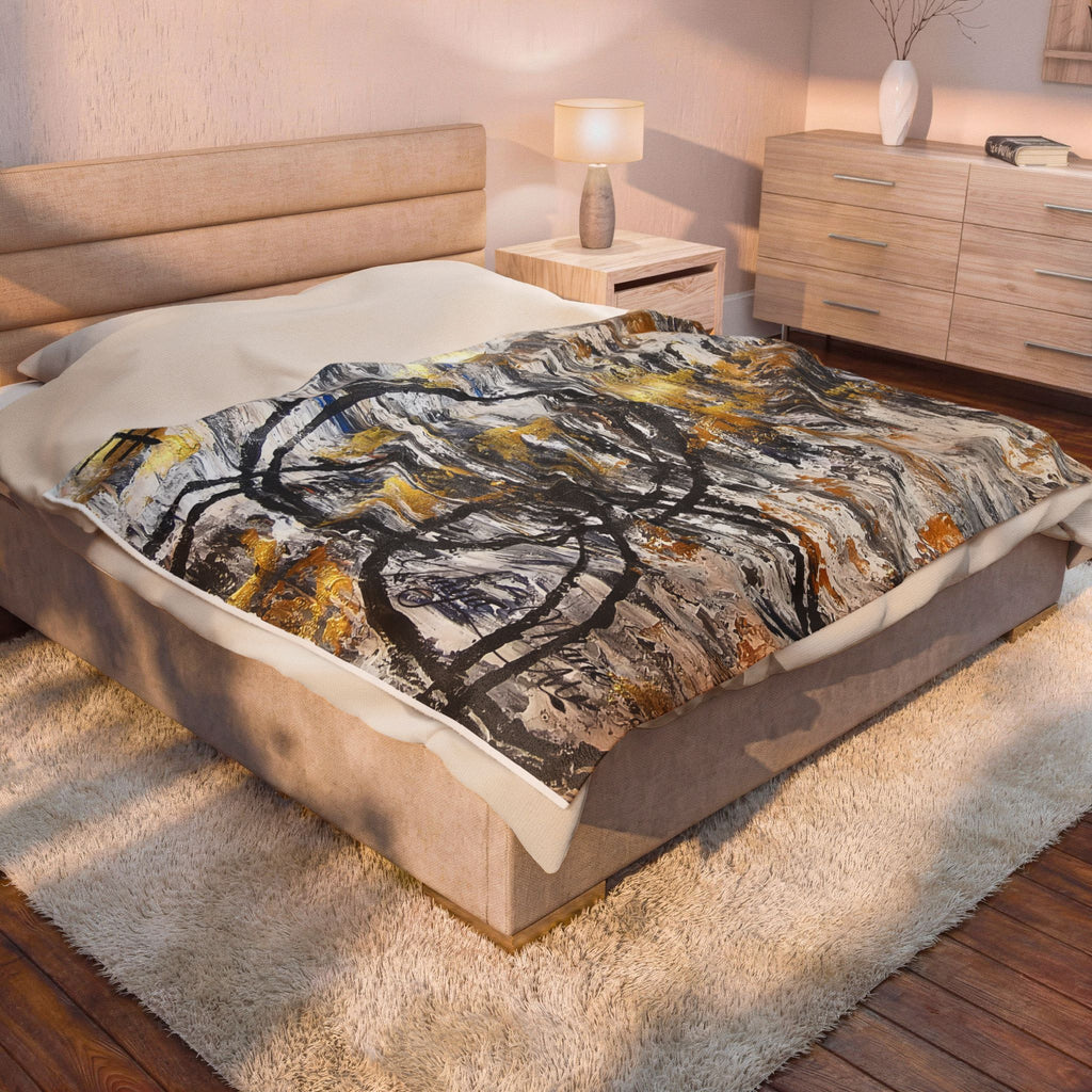 Velveteen plush blanket with abstract gold and charcoal circle motif centered