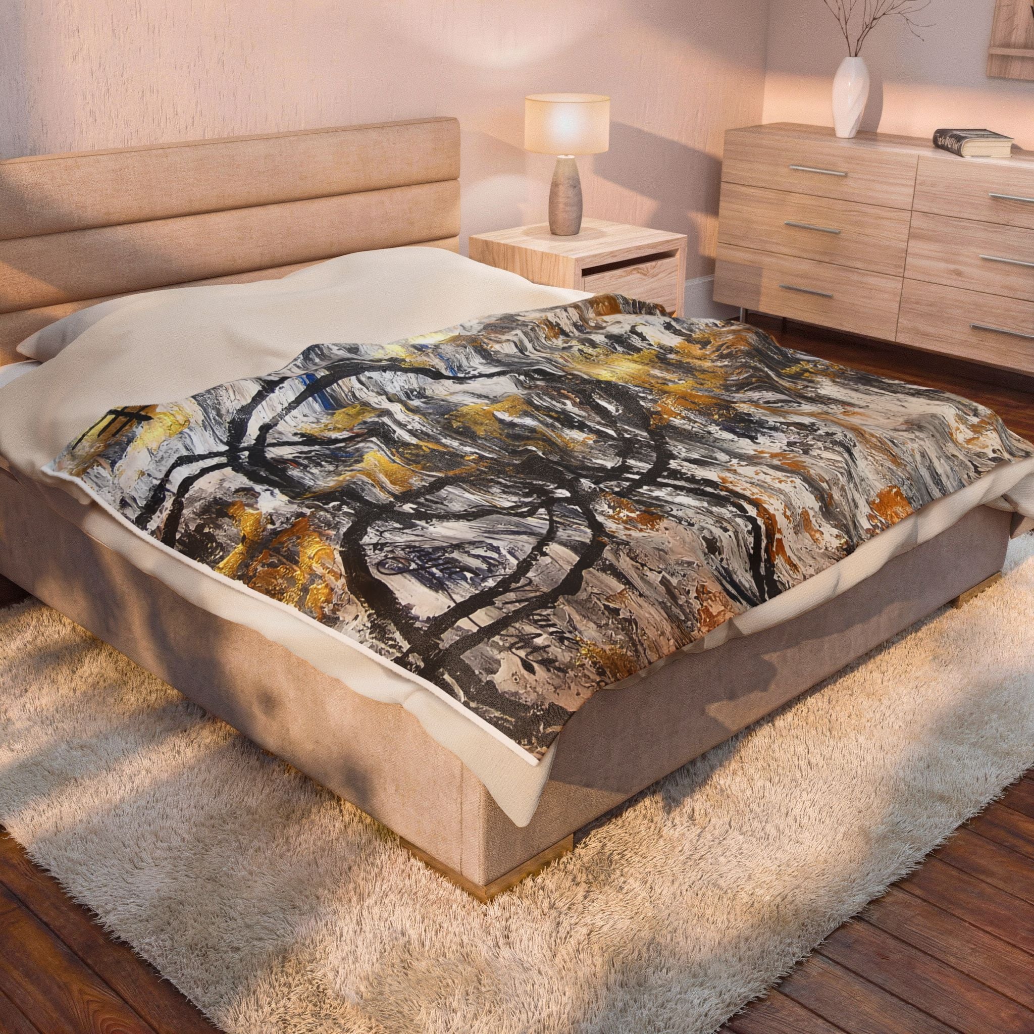 Velveteen plush blanket with abstract gold and charcoal circle motif centered