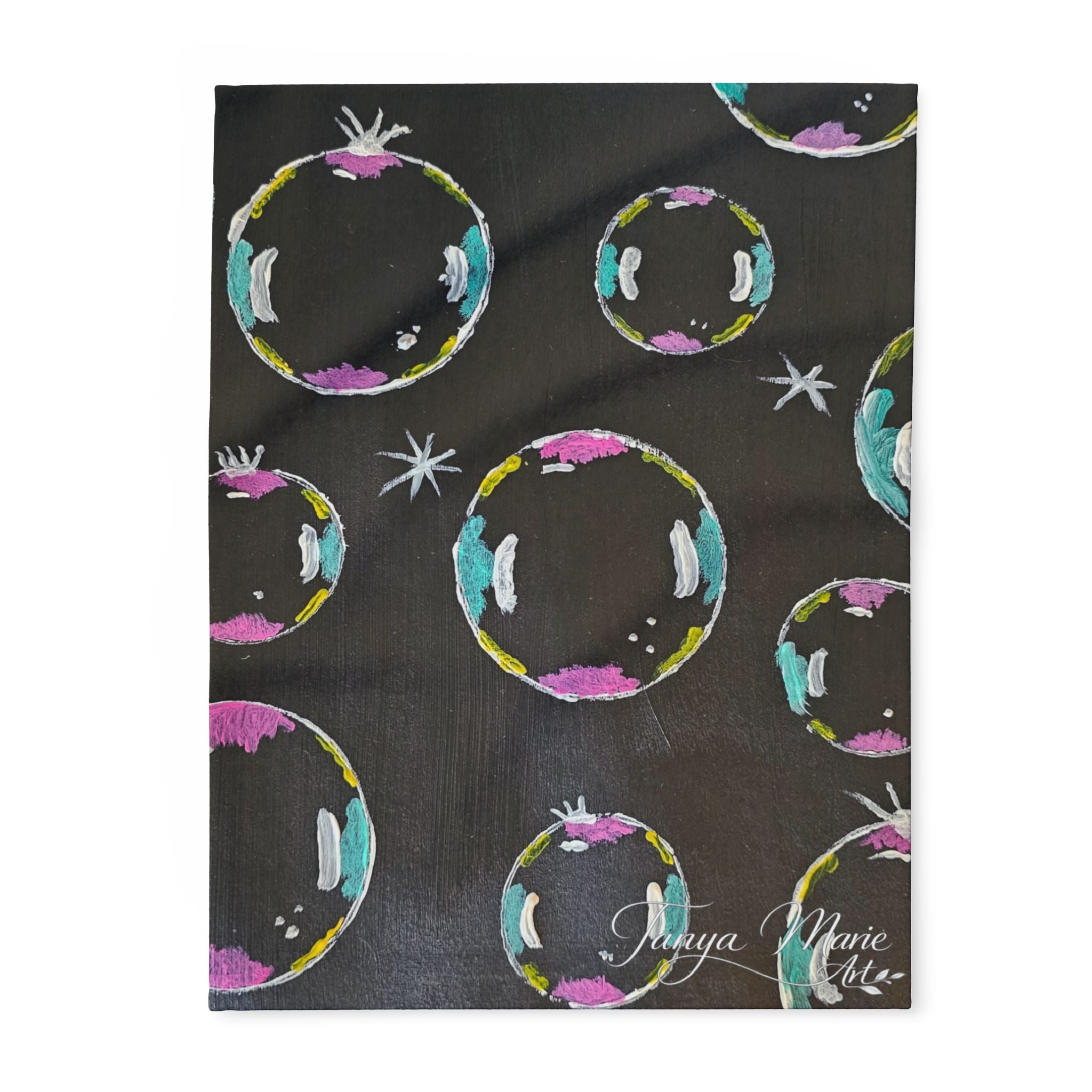 Fleece throw blanket, dark fabric covered in colorful bubble/planet circles and stars