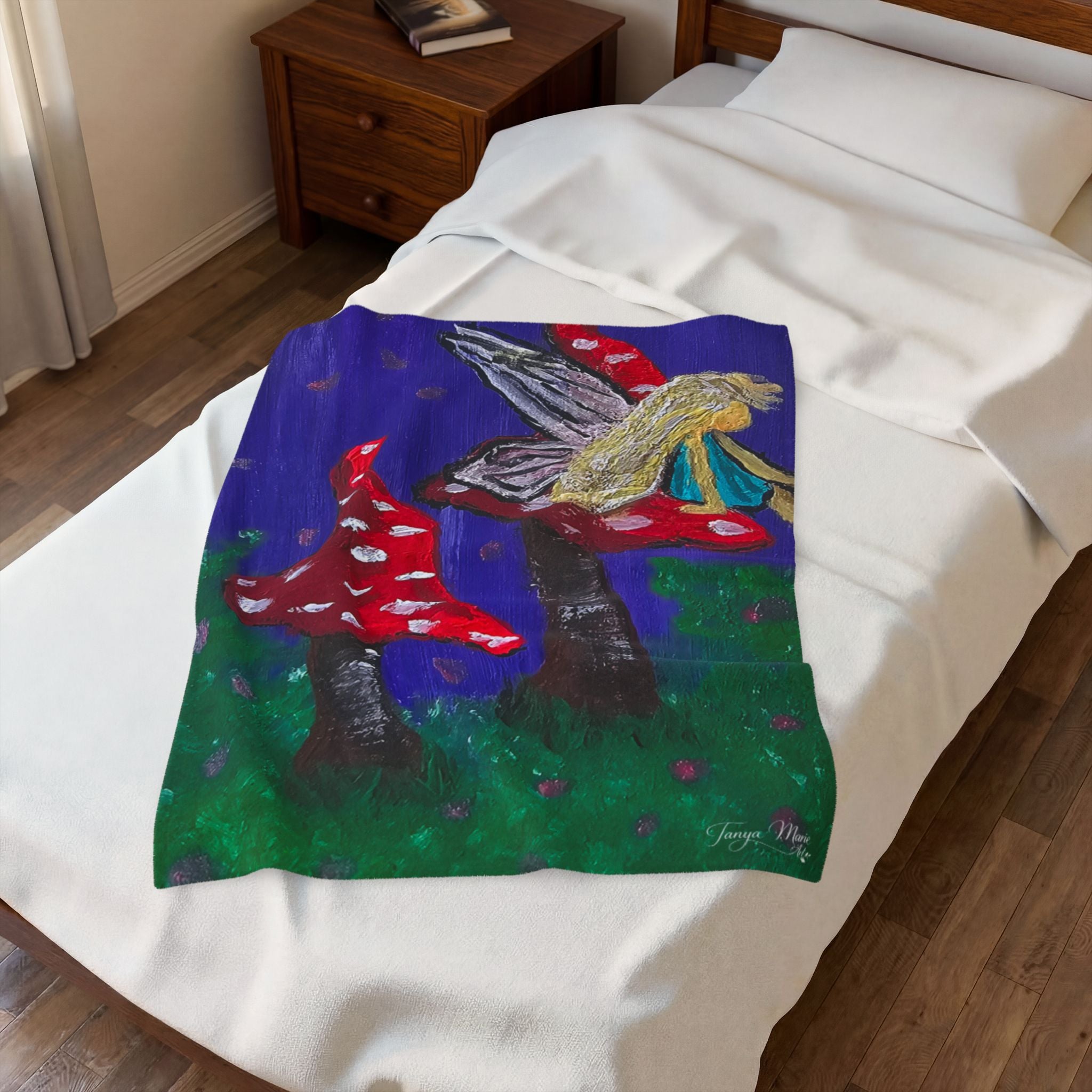 Plush velveteen blanket on bed with fairy, red toadstools, and blue-purple background