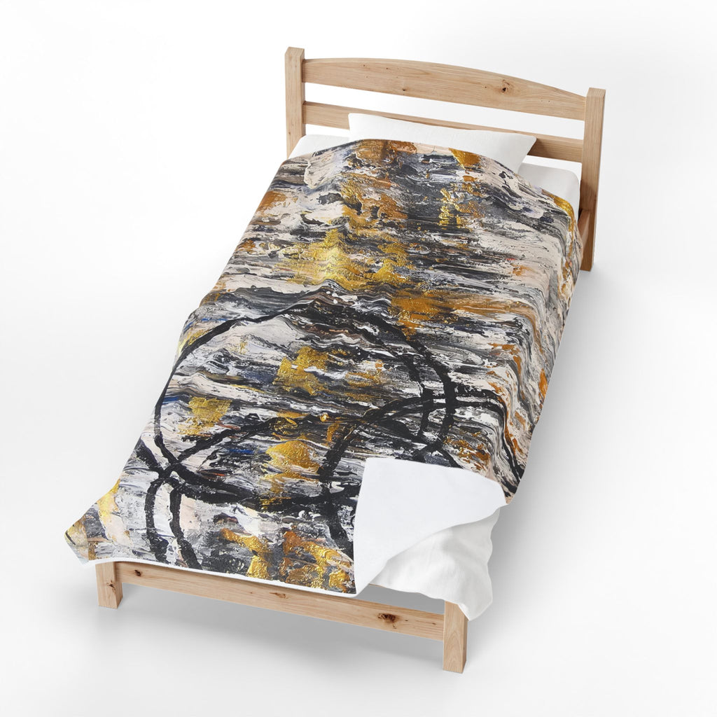 Velveteen plush blanket with abstract gold and charcoal circle design on white