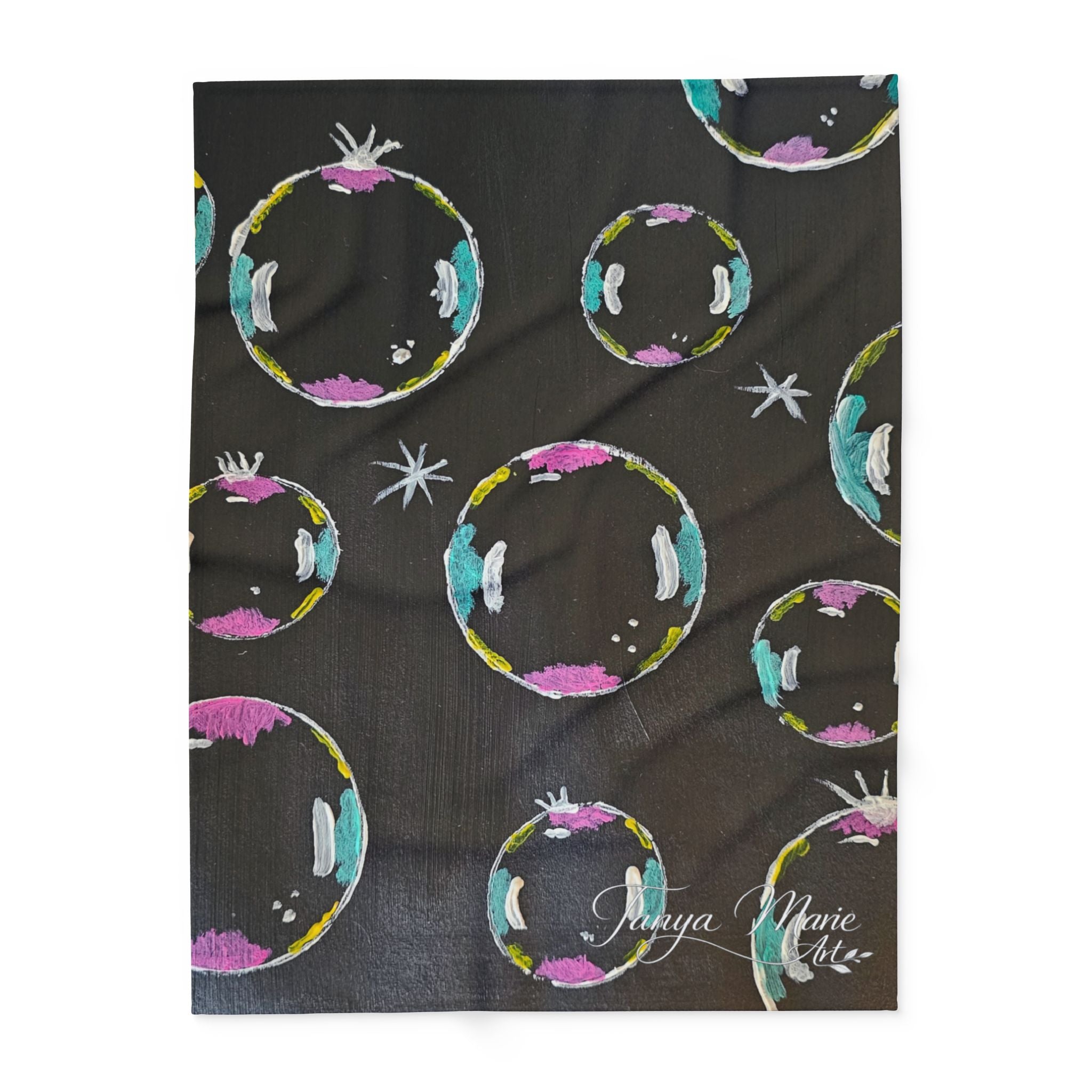 Fleece throw blanket with dark background and colorful bubble/planet motifs with white stars