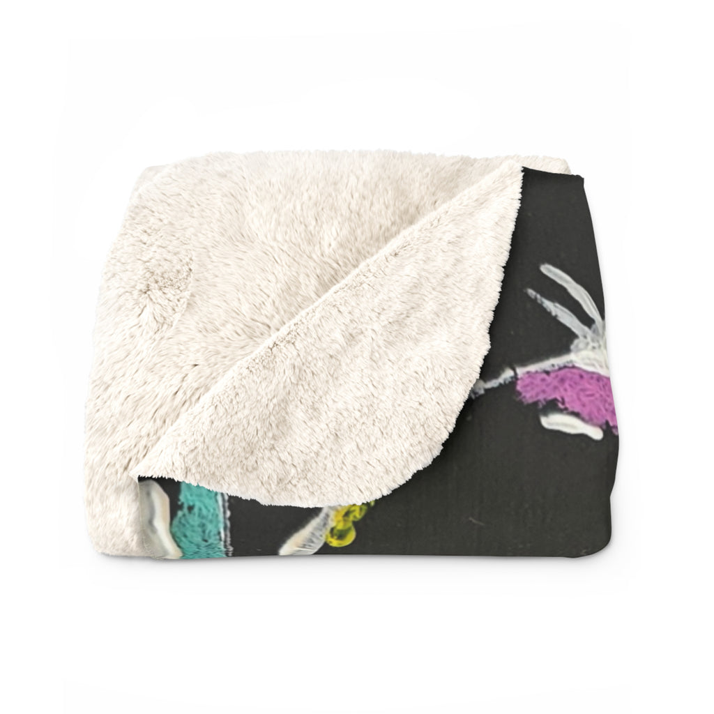 Sherpa fleece blanket folded, fluffy white sherpa side over dark gray bubble circle print