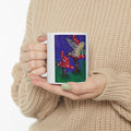 White ceramic coffee mug held in hands, with fairy and toadstool illustration