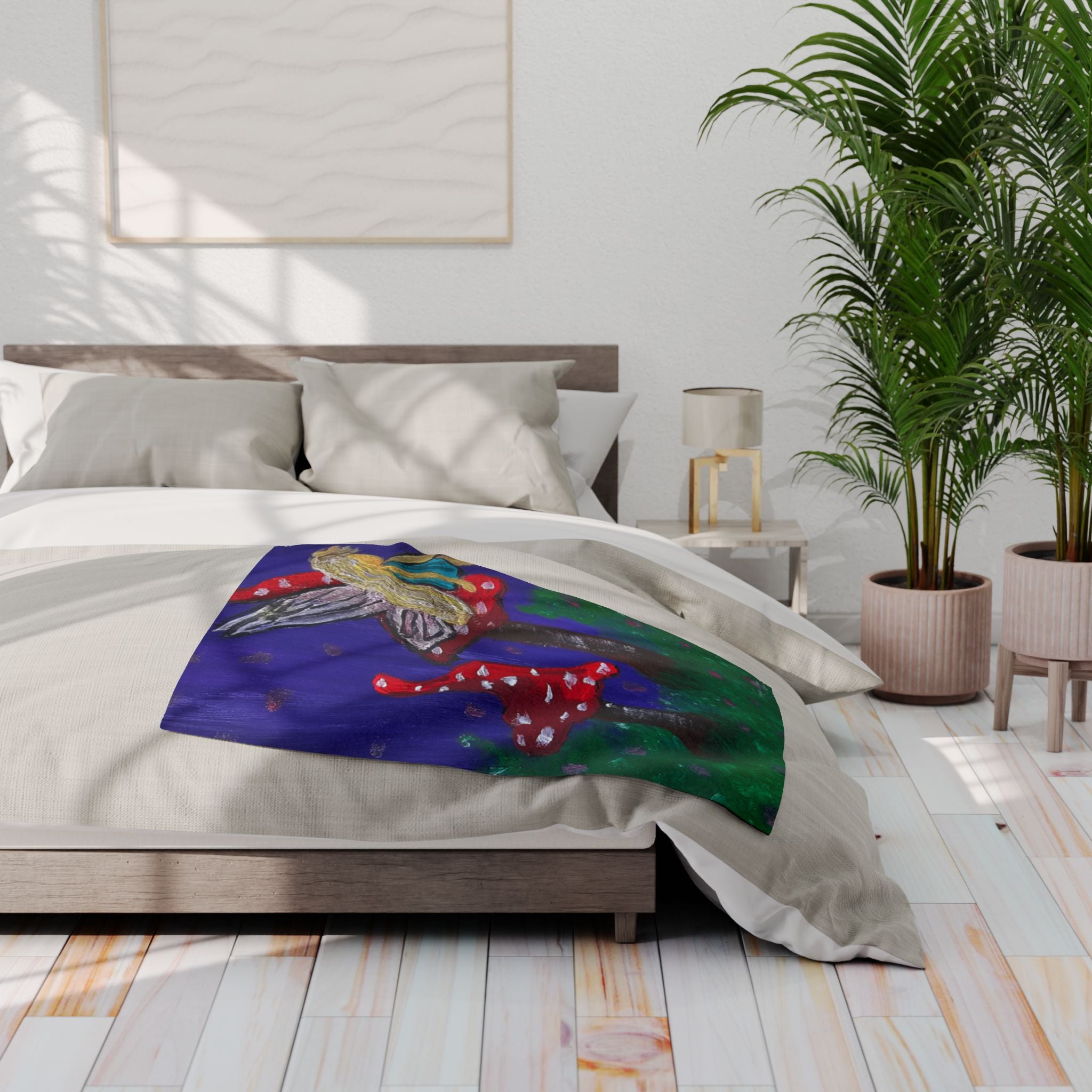 Whimsical fleece blanket on bed with blue fairy and red mushroom tree artwork