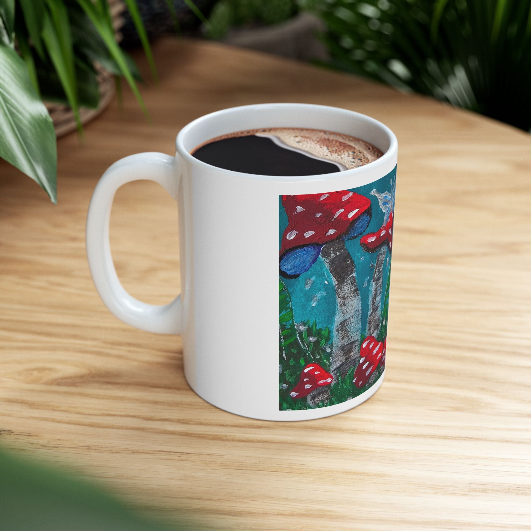 White ceramic mug with red mushroom garden print, filled with coffee