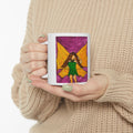 White ceramic mug held in hands, featuring a hand-drawn fairy wing watercolor panel.