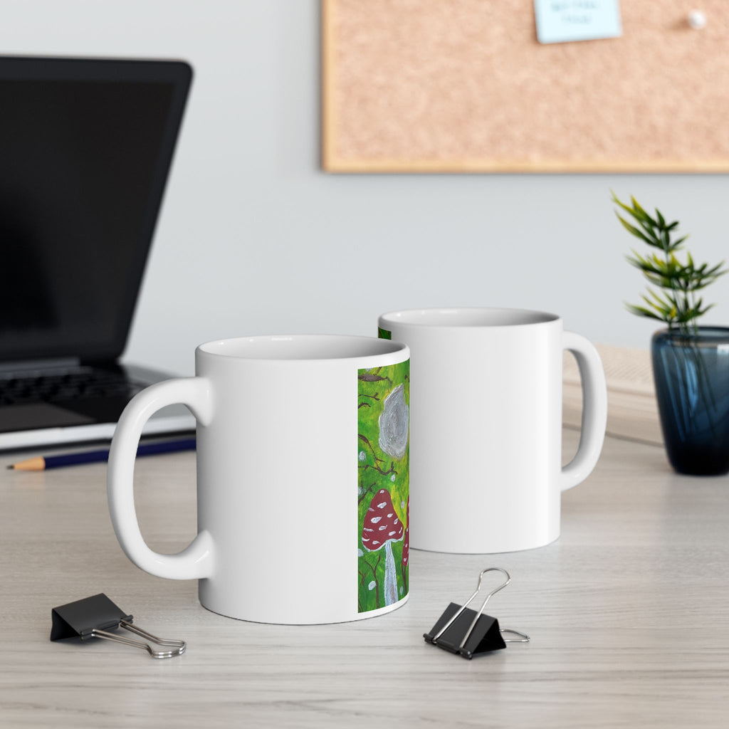 Set of two white ceramic mugs with green woodland and red toadstool artwork panels