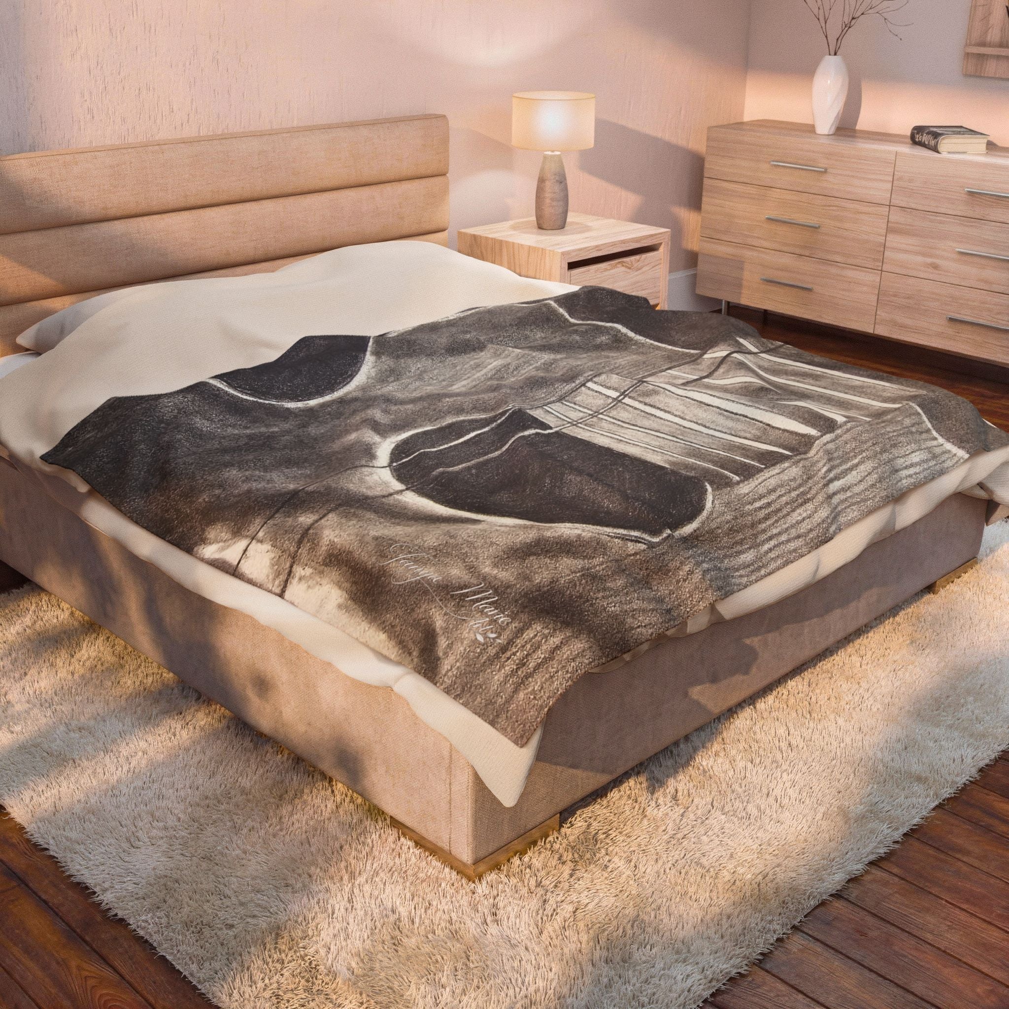Velveteen plush blanket on bed, gray guitar artwork with white strings and dark sound hole