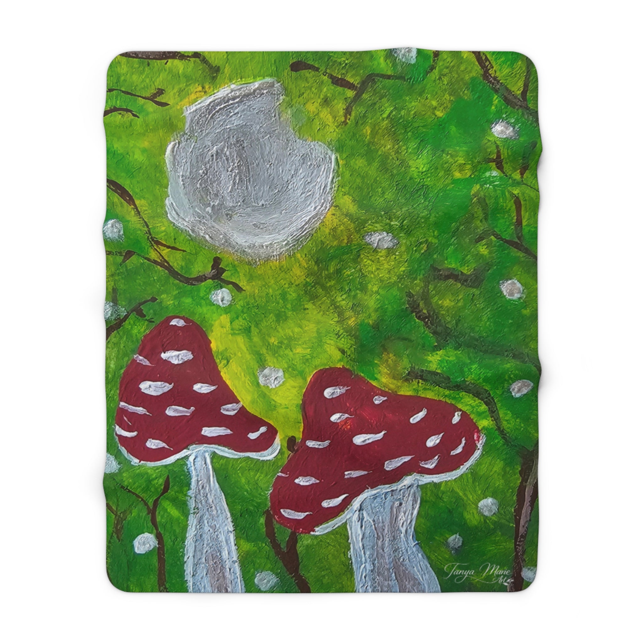 Sherpa blanket square with green forest scene, red mushroom clusters, and gray tree stump circles