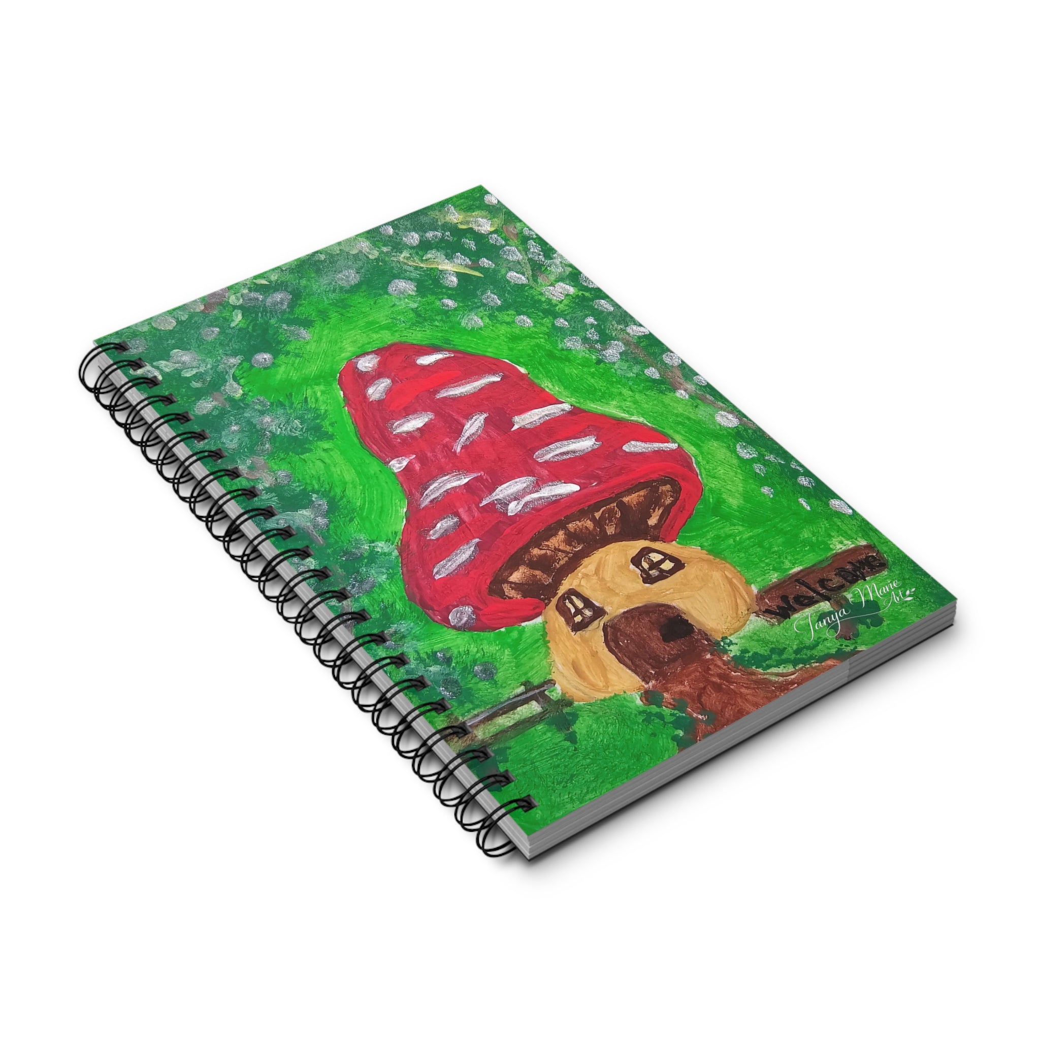 Spiral journal angled view, green cover with red mushroom and fairy house art