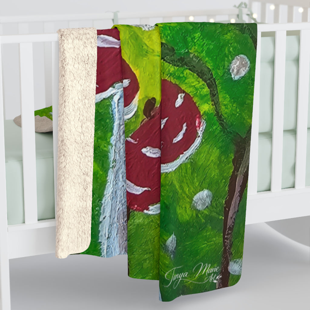 Sherpa blanket on crib rail showing off-white sherpa edge and green red mushroom forest print