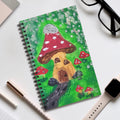 Spiral notebook with green fairy garden cover and mushrooms, including red-capped hut