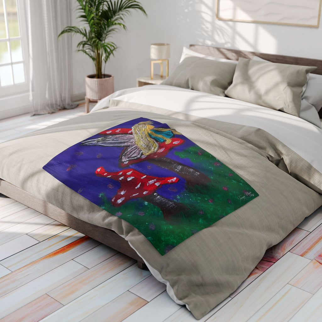 Whimsical fleece throw blanket with blue artwork of a fairy and red mushrooms on trees