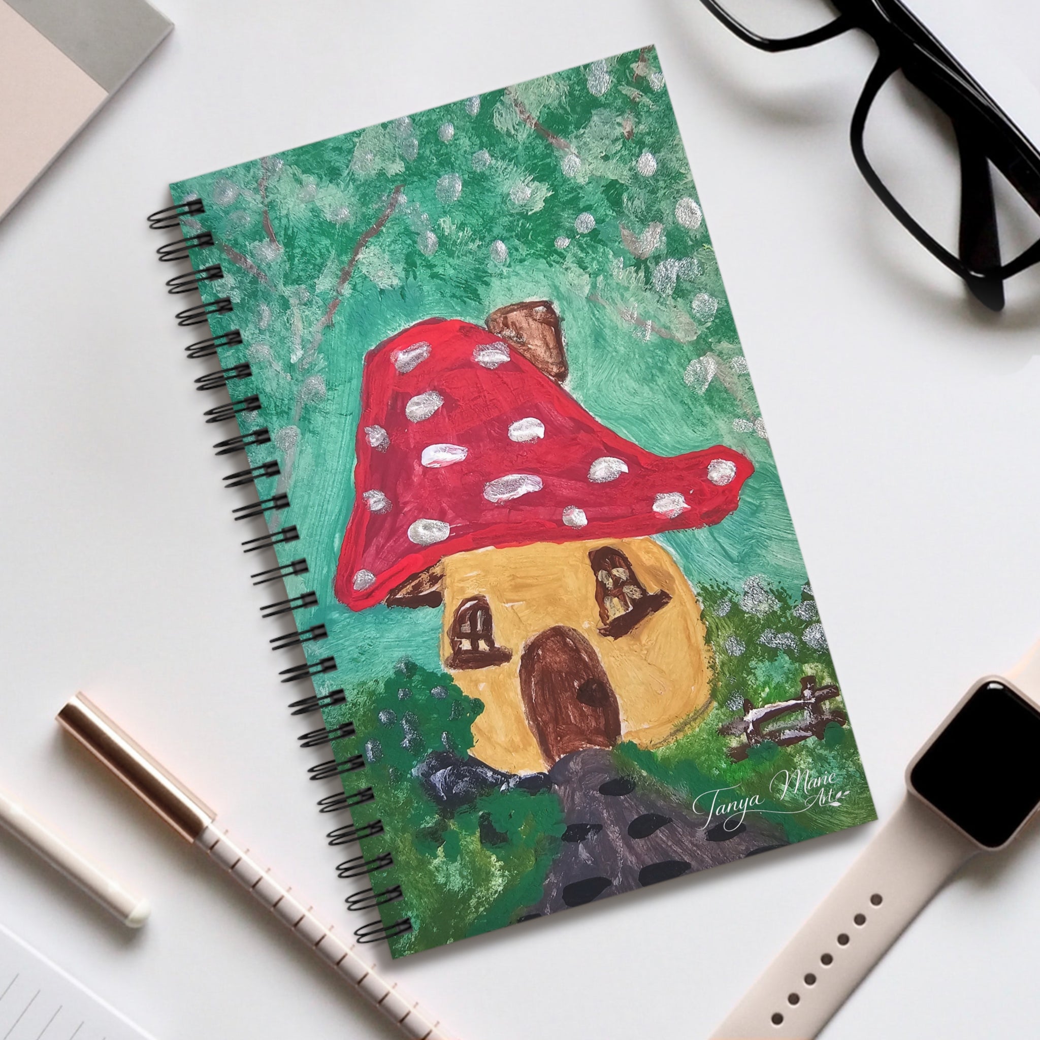 Spiral journal with mushroom cottage cover in green background and red mushroom cap.