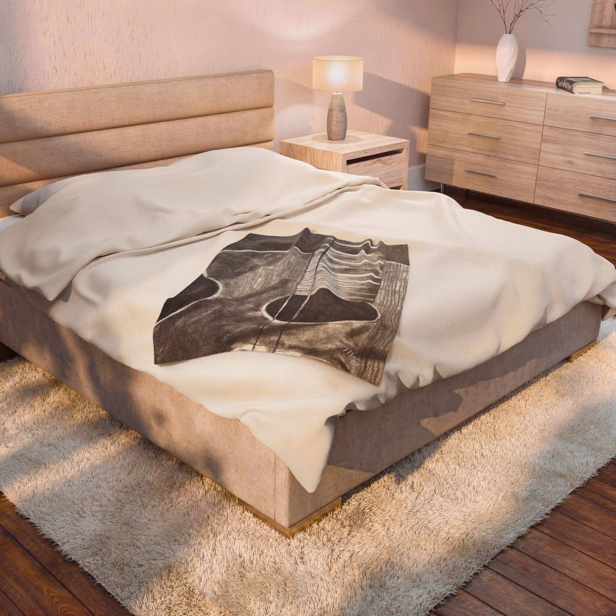 Plush blanket with acoustic guitar sketch graphic in dark gray on white bedding