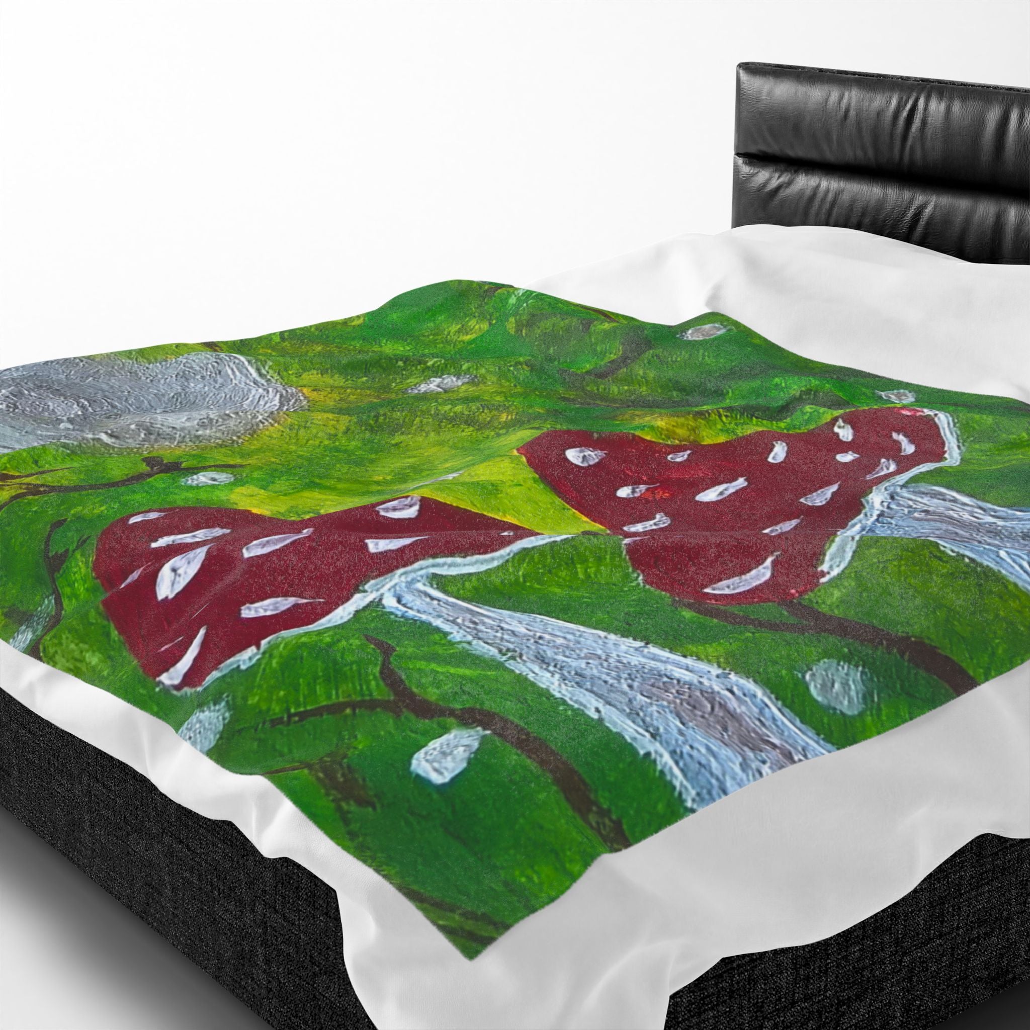 Velveteen blanket with green forest artwork and red spotted mushrooms